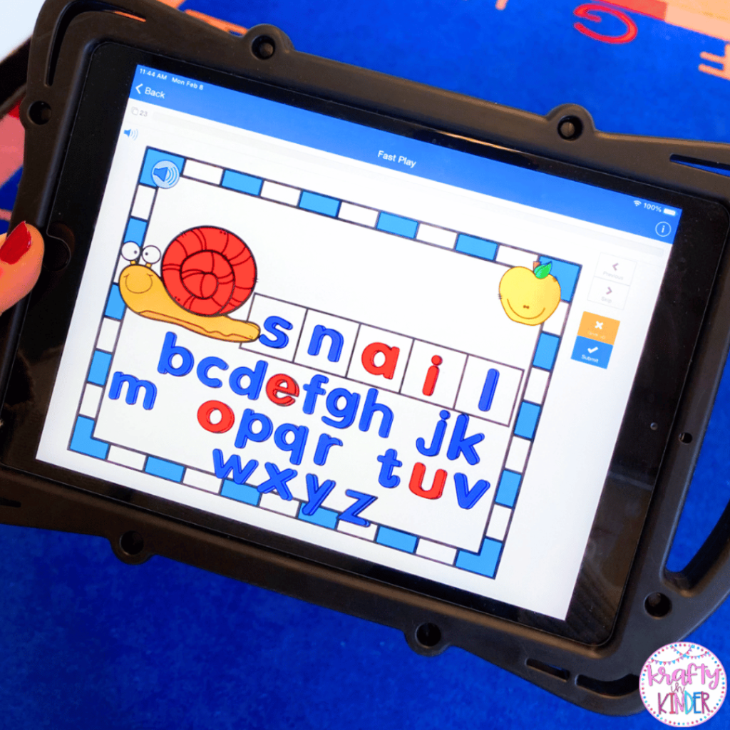 This photo features a student playing a digital spelling game on an iPad. They have drug and dropped letters to spell the word snail in order to match the picture on the screen.